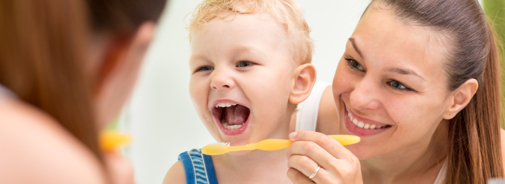 2 1 1 Mother Helping Child Brush in Mirror Toothbrushing bullet 3